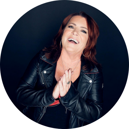 Kathleen Madigan laughs into the camera, similar to the way I imagine she laughs in the face of evil.